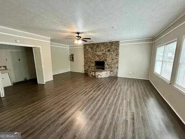 wooden floor in an empty room with a fireplace