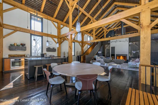 a living room with furniture a fireplace and wooden floor