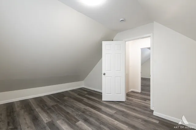 an empty room with wooden floor and closet