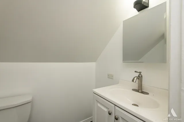 a bathroom with a sink a toilet and mirror