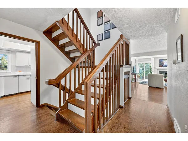 a view of entryway livingroom and hall with wooden floor