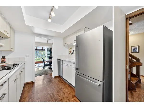 a kitchen with stainless steel appliances a refrigerator and a stove top oven