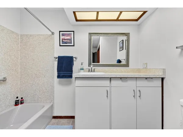 a bathroom with a sink a mirror and a bathtub