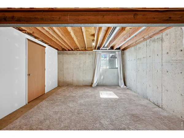 a view of a room with a wooden ceiling fan