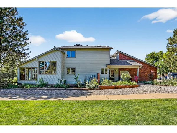 a front view of house with yard and green space
