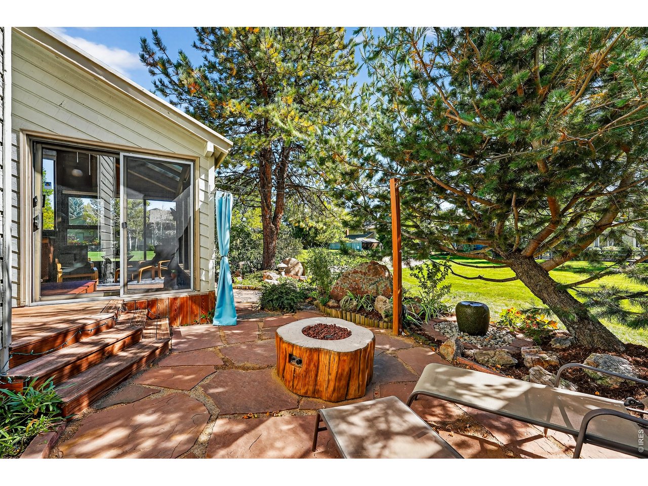 4935 Sundance Square Boulder, CO 80301 - Photo 8 of 49 A private deck, new flagstone patio with a gas firepit, and low-maintenance gardens with integrated sprinklers and drip irrigation create a serene, turnkey outdoor retreat.