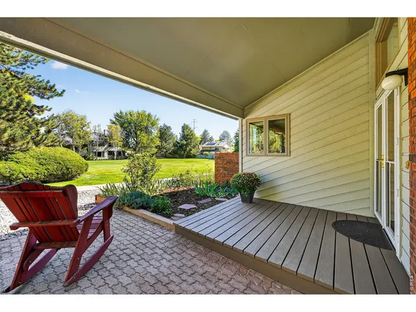 a view of an outdoor sitting area with wooden floor