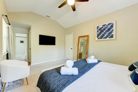 a bedroom with a bed and a flat screen tv