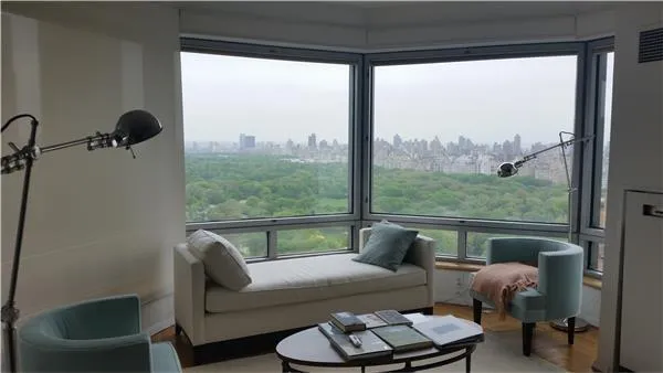 a living room with furniture and large windows
