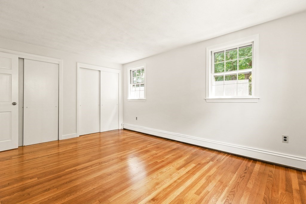 68 School Street Lexington, MA 02421 - Photo 12 of 24 an empty room with wooden floor and windows