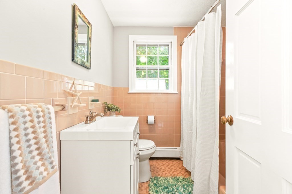 68 School Street Lexington, MA 02421 - Photo 18 of 24 a bathroom with a sink toilet and window