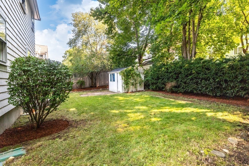 68 School Street Lexington, MA 02421 - Photo 21 of 24 a view of a house with backyard and a tree
