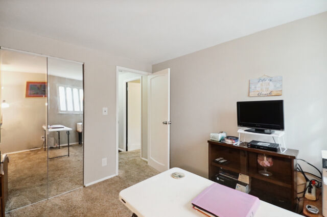 808 Westfield Drive Champaign, IL 61821 - Photo 16 of 31 a view of a workspace with furniture and a flat screen tv