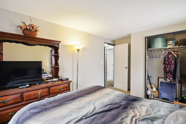 808 Westfield Drive Champaign, IL 61821 - Photo 18 of 31 a bedroom with a bed and a flat screen tv