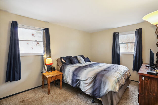 808 Westfield Drive Champaign, IL 61821 - Photo 19 of 31 a bedroom with a bed wooden floor and window