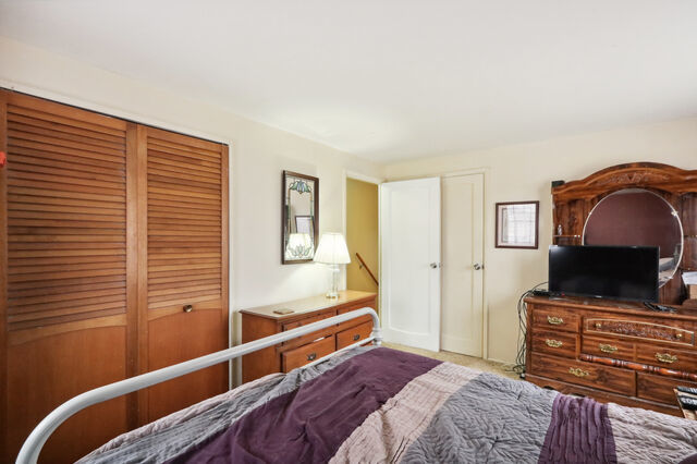 808 Westfield Drive Champaign, IL 61821 - Photo 20 of 31 a bedroom with a bed and a flat screen tv