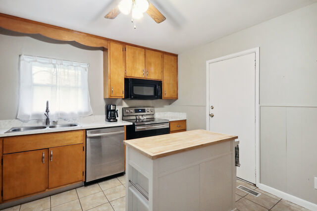 808 Westfield Drive Champaign, IL 61821 - Photo 5 of 31 a kitchen with a sink a stove and chairs