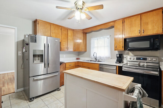 808 Westfield Drive Champaign, IL 61821 - Photo 6 of 31 a kitchen with stainless steel appliances a refrigerator a stove a sink and a microwave