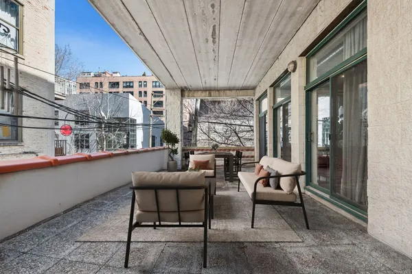 a view of a patio with a table and chairs