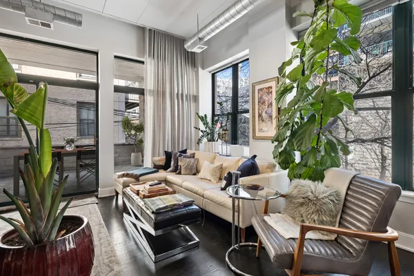 a living room with patio table and a potted plant