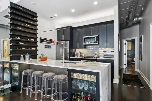 a kitchen with stainless steel appliances granite countertop a stove and a refrigerator