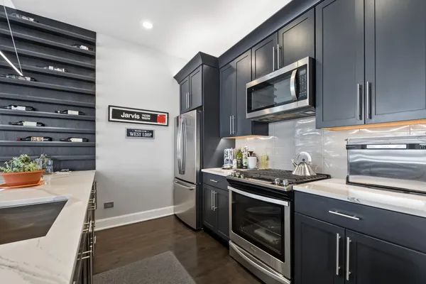a kitchen with stainless steel appliances and view of cabinets