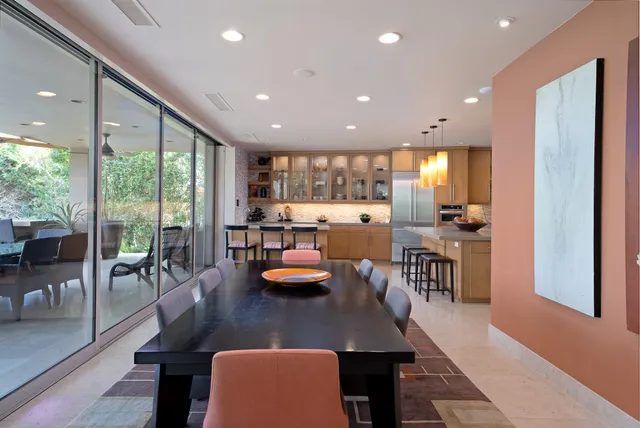 a kitchen with a large window and sitting area
