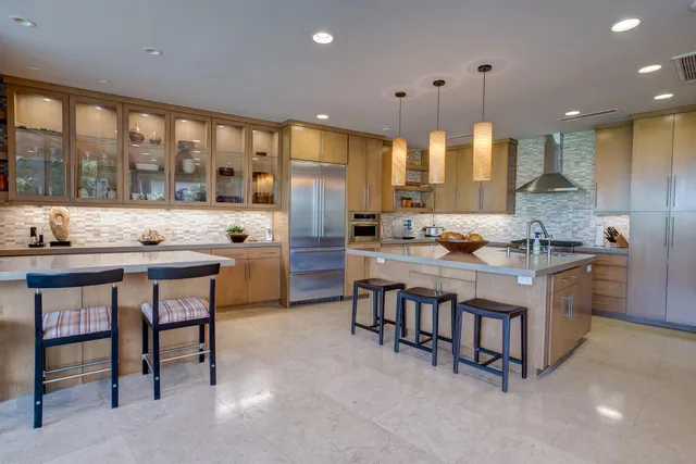 a kitchen with stainless steel appliances granite countertop a stove and a refrigerator