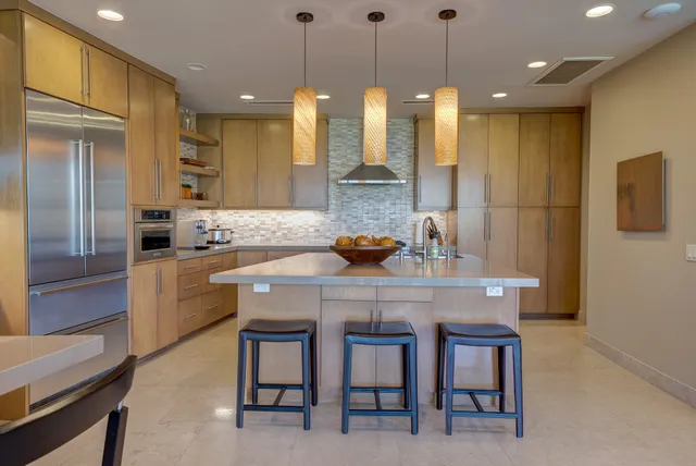 a kitchen with granite countertop a sink refrigerator and cabinets
