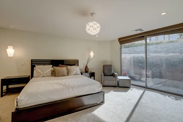 a bedroom with a bed and a large window