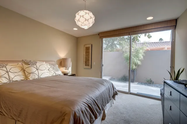 a bedroom with a large bed and a large window