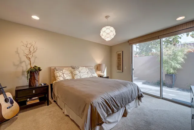 a bedroom with a bed and a large window