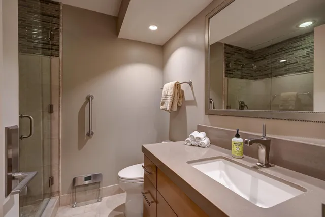 a bathroom with a sink toilet and shower