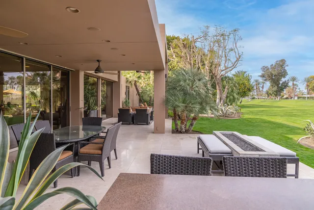 a view of a patio with a dining table and chairs