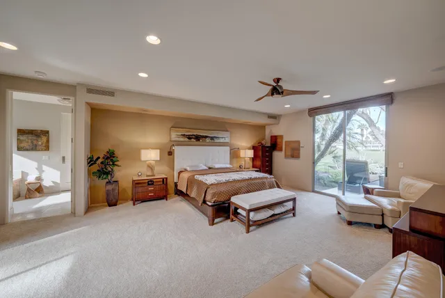 a spacious bedroom with a bed and a large window