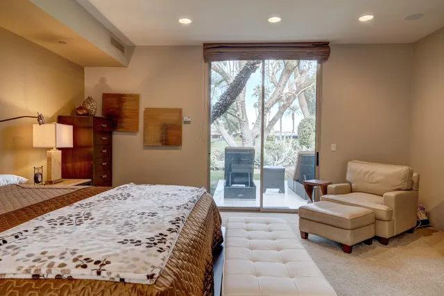 a bedroom with a bed and glass window