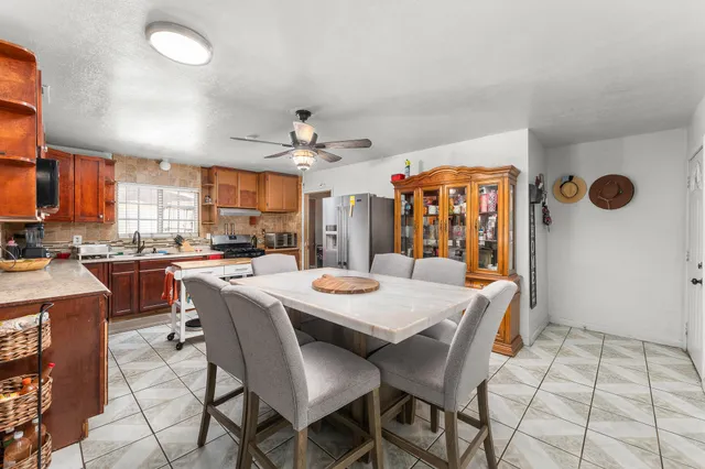 a view of a dining room with furniture and chandelier