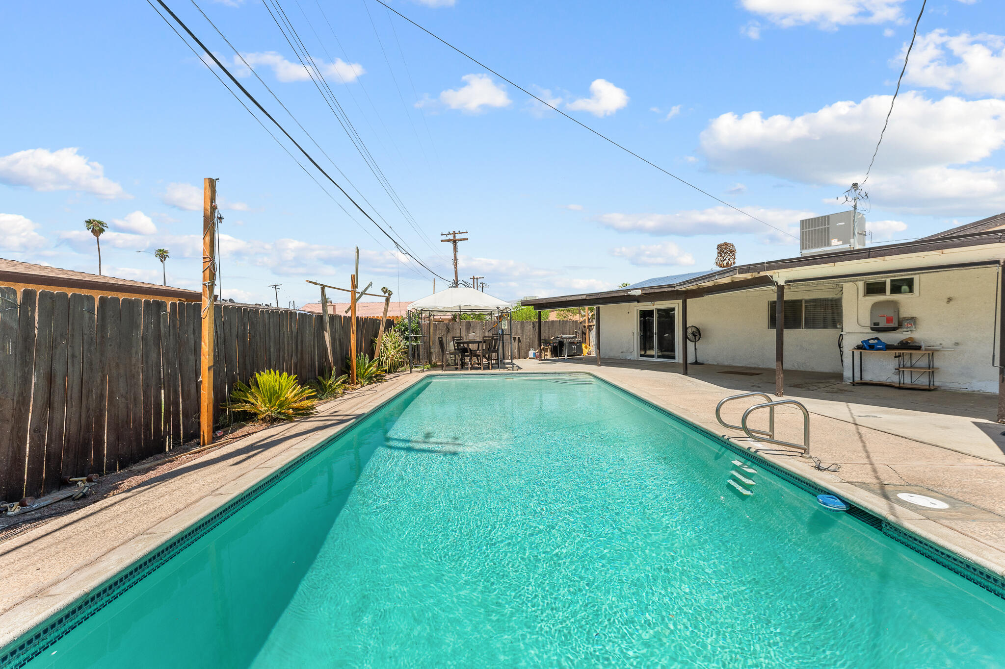 83307 Tourmaline Avenue Indio, CA 92201 - Photo 30 of 38 a swimming pool with yard in front of it