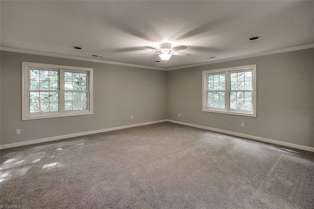 2601 Kilpatrick White Road Greensboro, NC 27406 - Photo 11 of 30 Master suite has recessed lighting and a beautiful view of the wooded, private backyard.