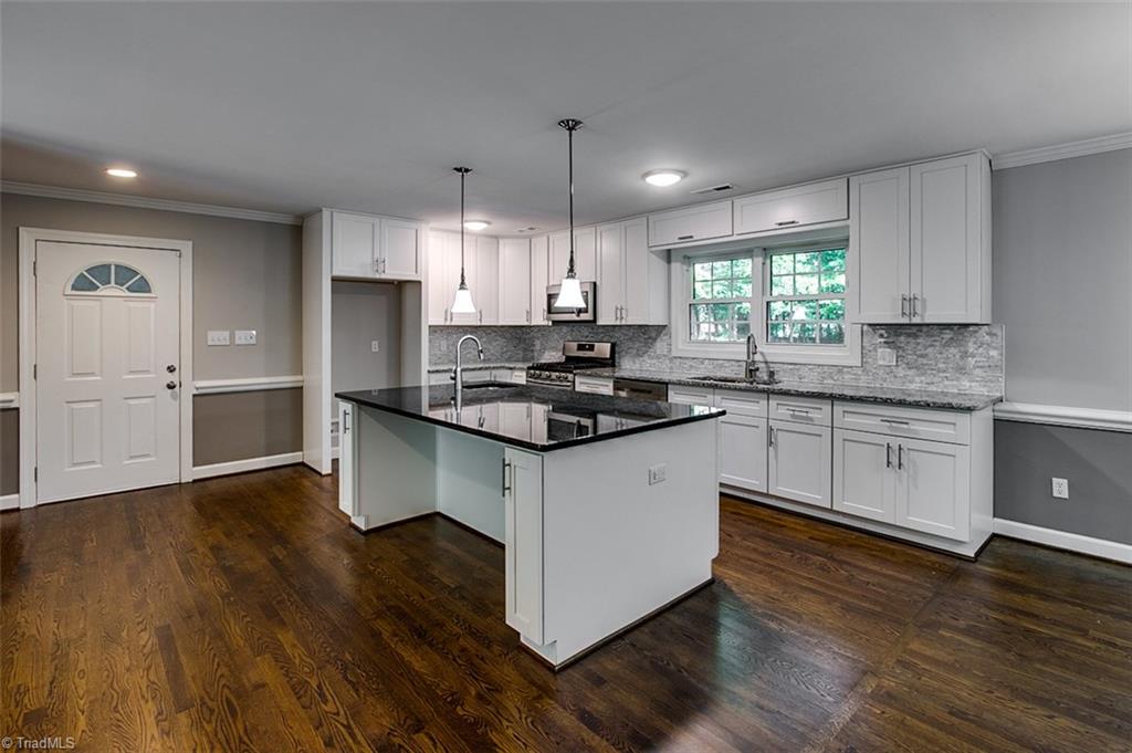 2601 Kilpatrick White Road Greensboro, NC 27406 - Photo 6 of 30 Custom details make this kitchen shine! Modern cabinetry, stone backsplash and stainless appliances make this kitchen a cook's dream.