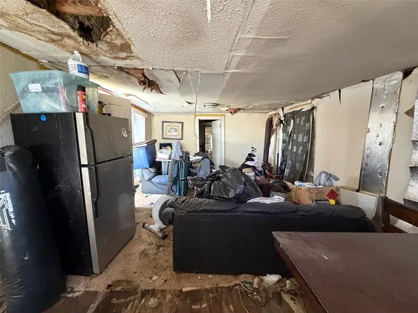 a view of a room with water heater refrigerator