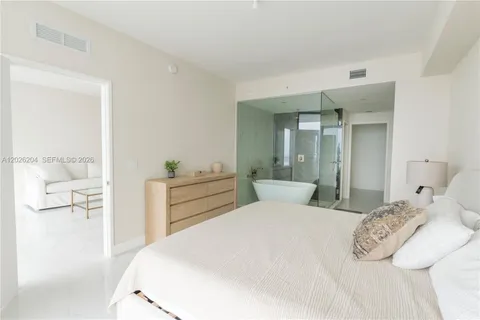 a bed room with a bed and a large mirror