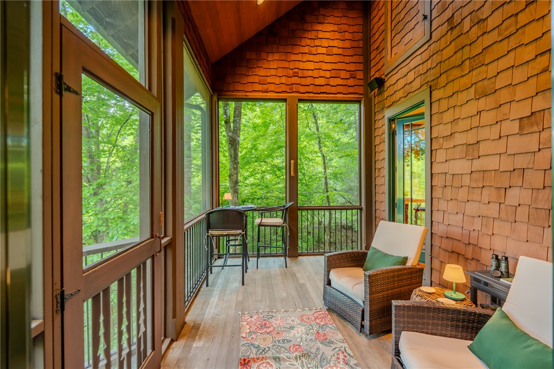 102 State Rd S-39-143 Sunset, SC 29685 - Photo 22 of 47 This serene screened porch offers a tranquil retreat surrounded by nature's beauty.