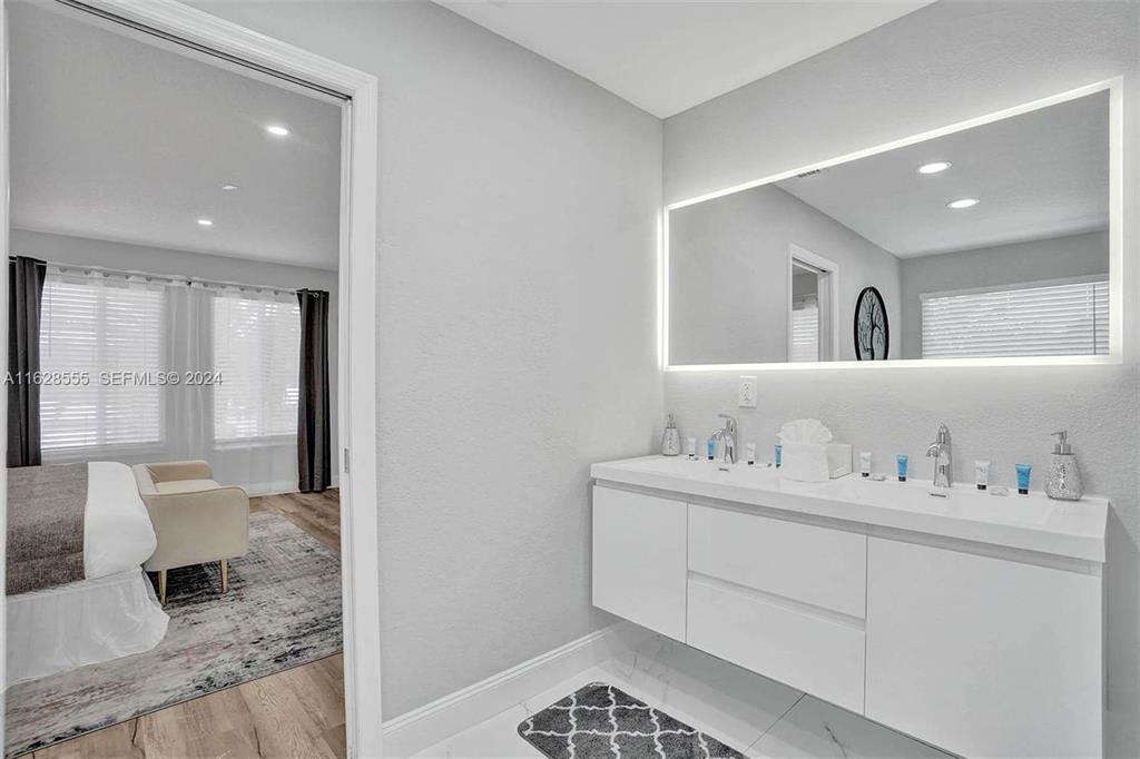 3421 Dover Road Pompano Beach, FL 33062 - Photo 13 of 22 a bathroom with a sink and a mirror