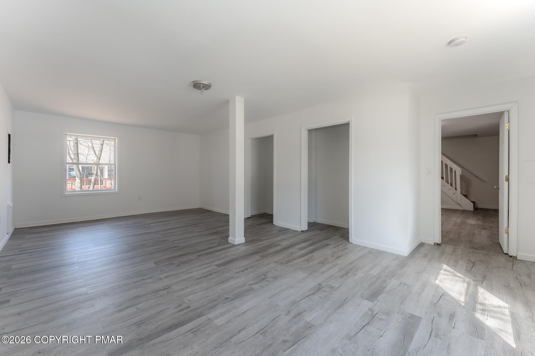 7624 Sawmill Road Tobyhanna, PA 18466 - Photo 15 of 55 an empty room with wooden floor and windows