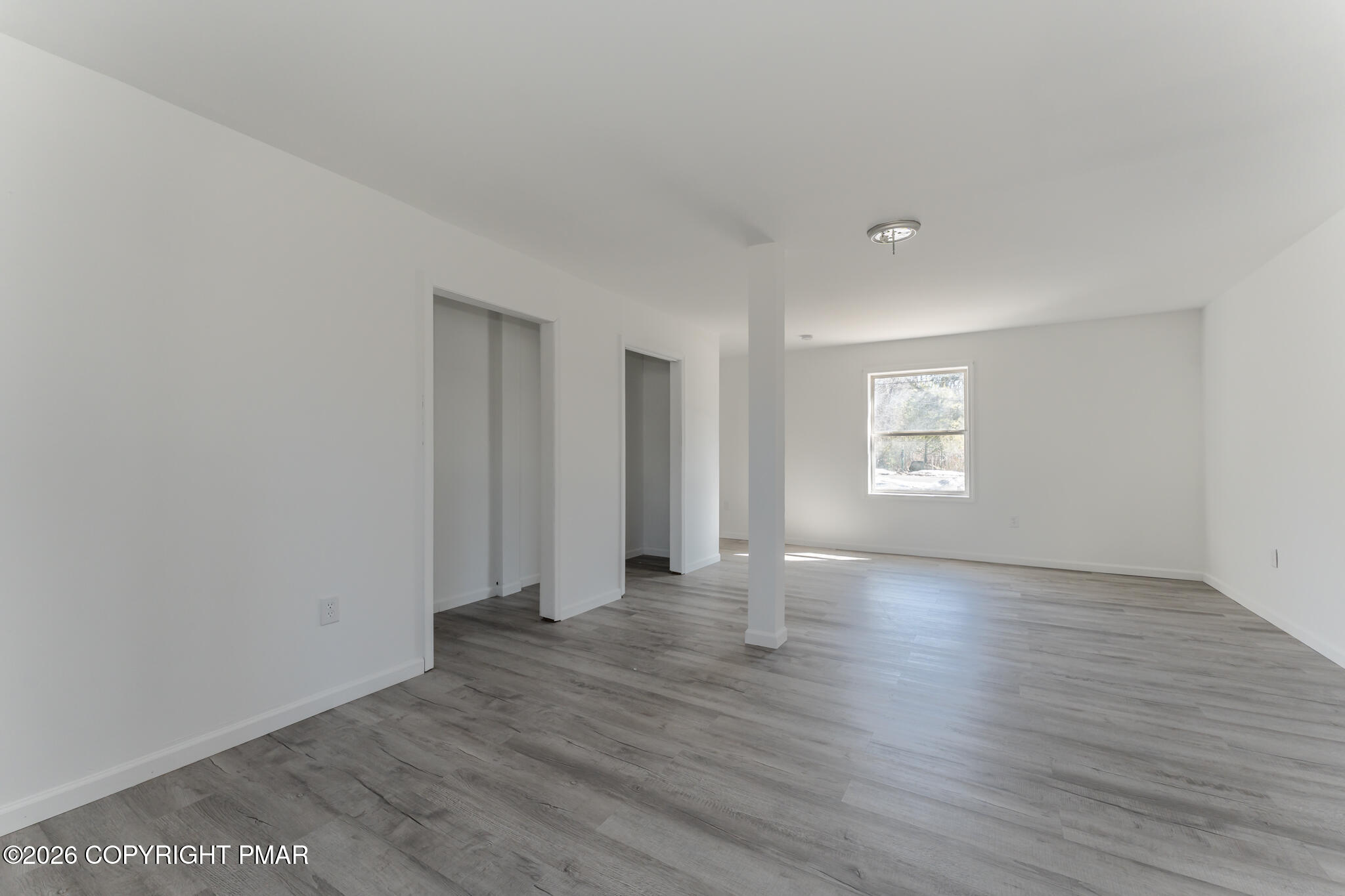 7624 Sawmill Road Tobyhanna, PA 18466 - Photo 16 of 55 an empty room with wooden floor and windows