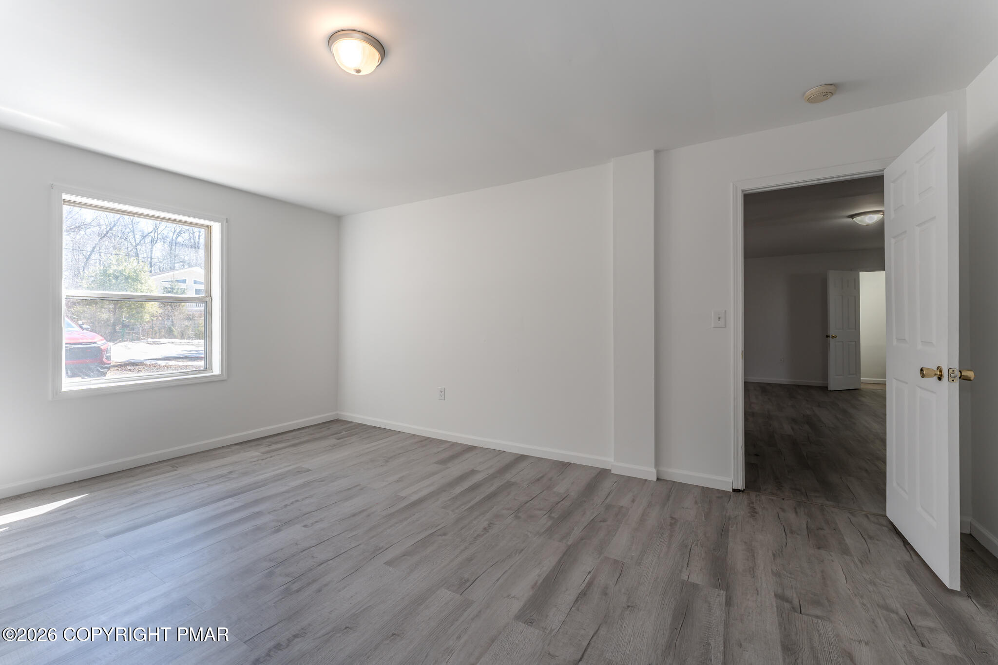 7624 Sawmill Road Tobyhanna, PA 18466 - Photo 20 of 55 an empty room with wooden floor and windows