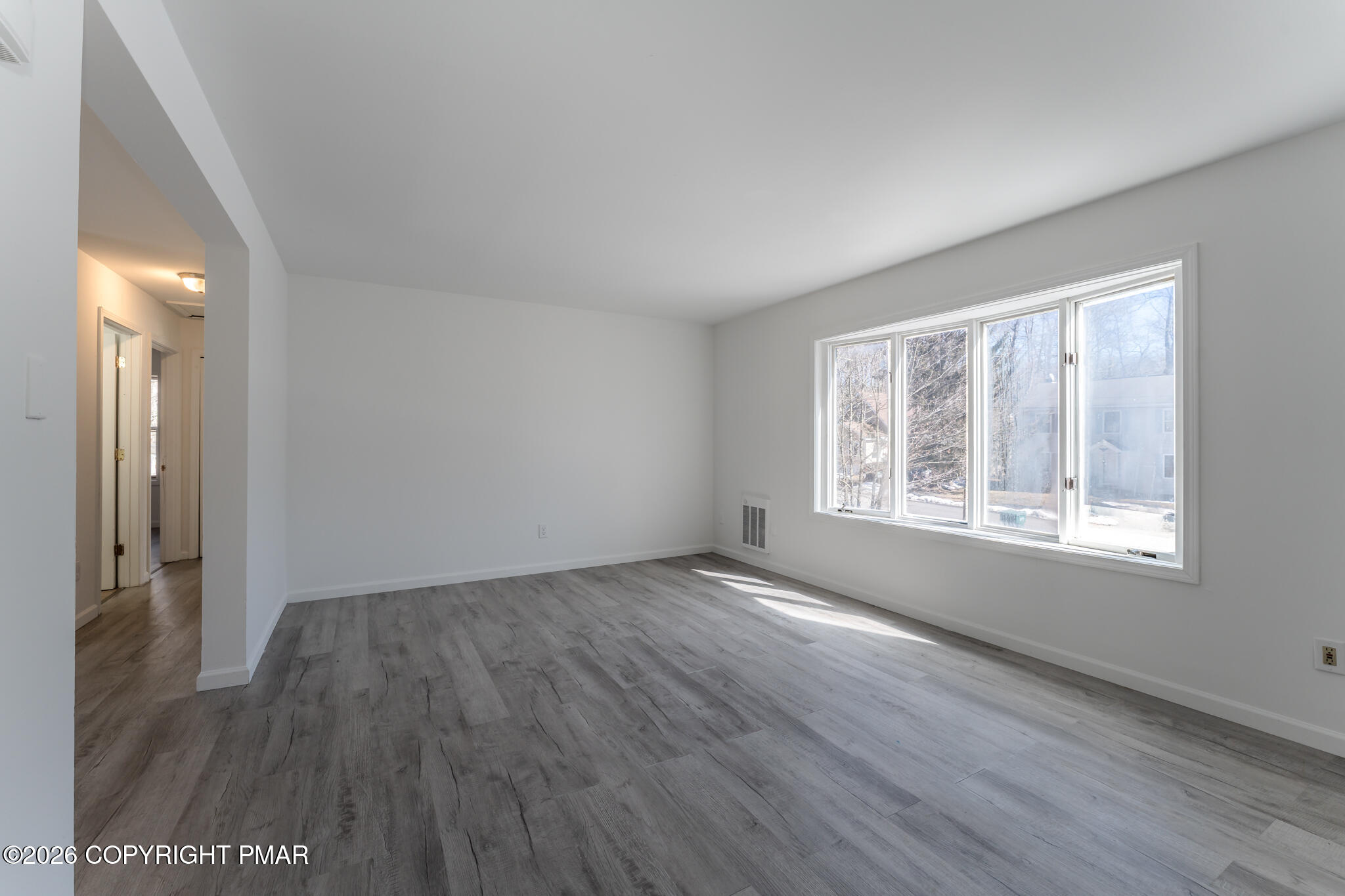 7624 Sawmill Road Tobyhanna, PA 18466 - Photo 26 of 55 an empty room with wooden floor and windows