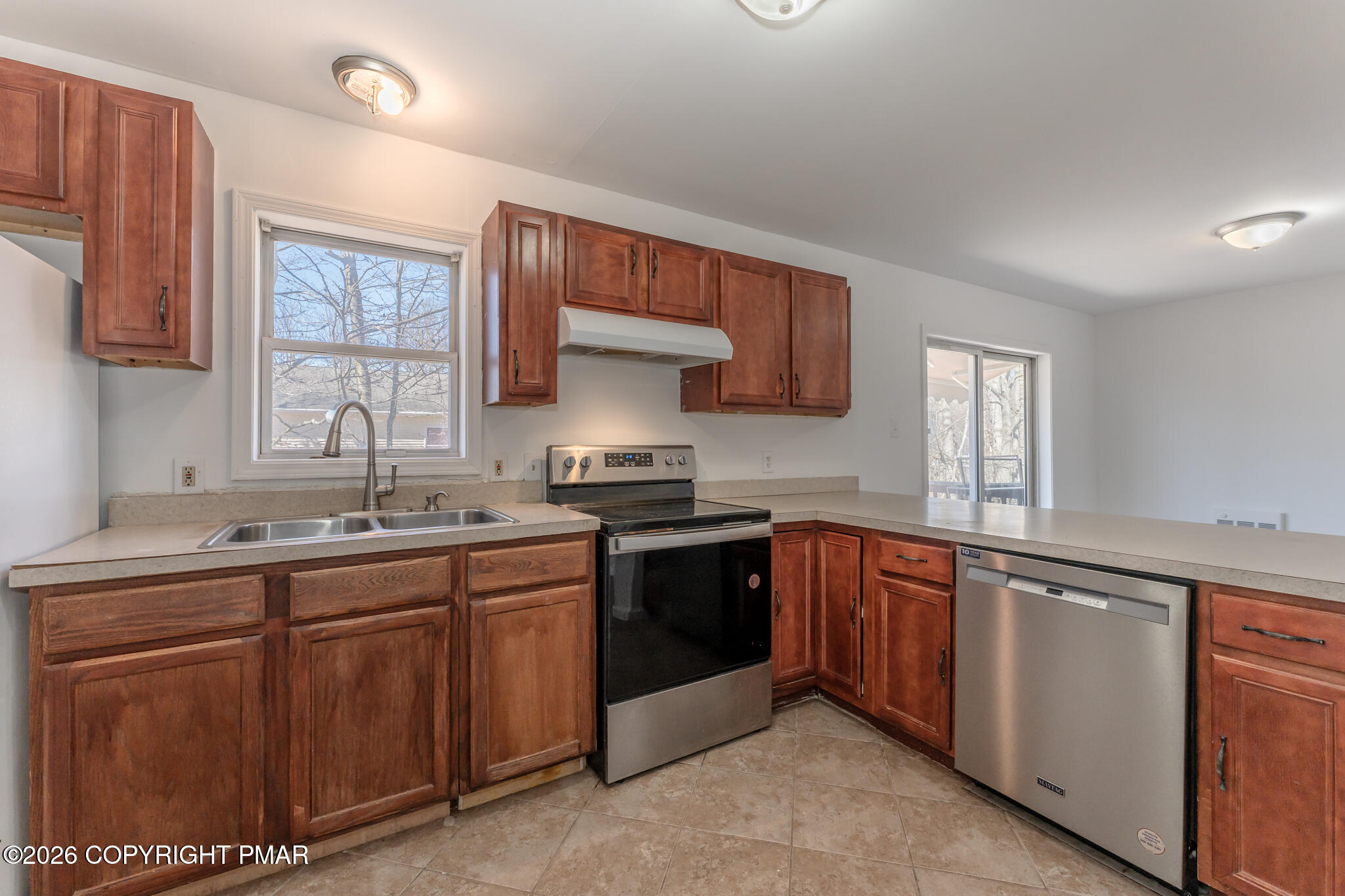 7624 Sawmill Road Tobyhanna, PA 18466 - Photo 30 of 55 a kitchen with stainless steel appliances granite countertop a sink stove and cabinets