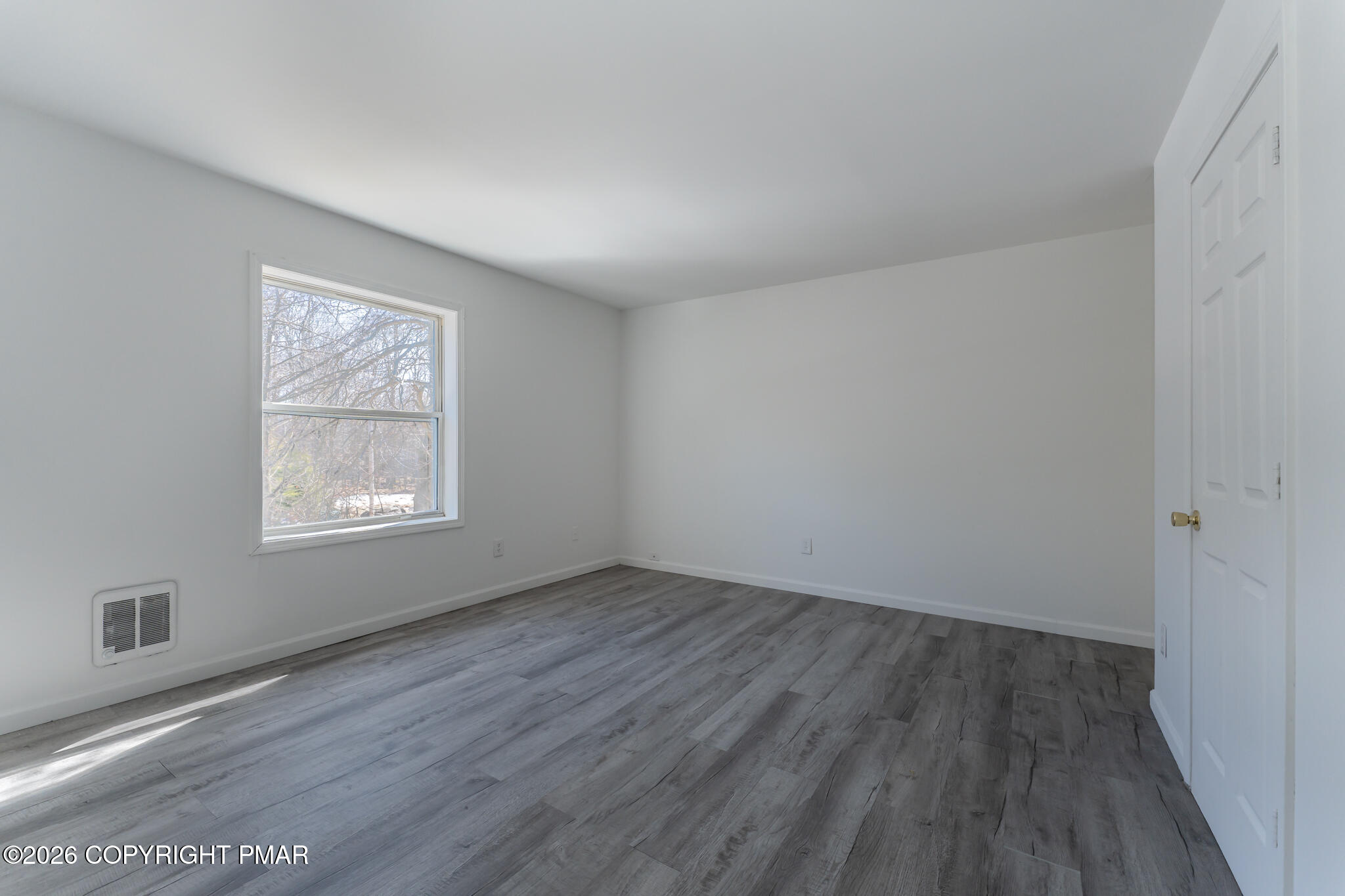 7624 Sawmill Road Tobyhanna, PA 18466 - Photo 33 of 55 a view of an empty room with wooden floor and a window